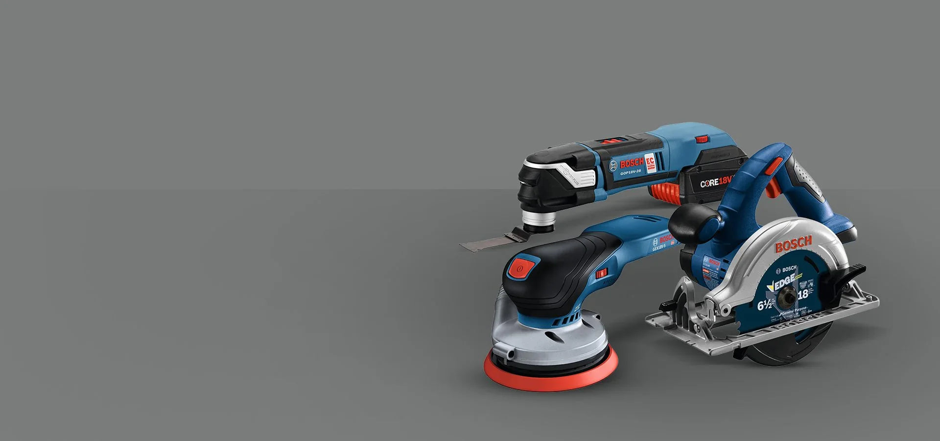 Три електрически инструмента Bosch: циркуляр, ъглошлайф и мултифункционален уред, на сив фон