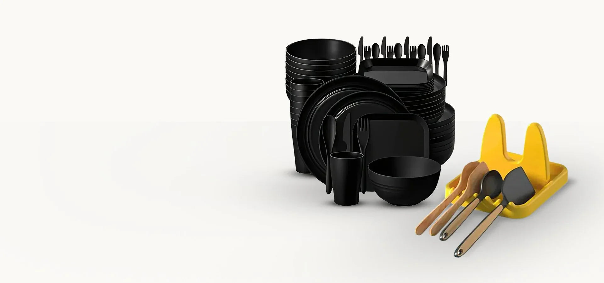 Комплект черни чинии, купи и прибори за хранене, до жълта поставка с кухненски бъркалки